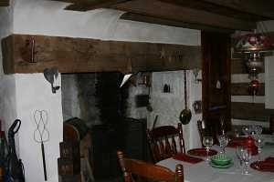 fireplace behind a kitchen table set for dinner