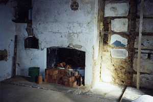 an old fireplace with dozens of red bricks stacked in front of it and in buckets