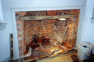 a crumbling brick fireplace - before