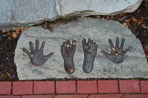 an engraved stone with feet and hand prints that reads Ben - 5