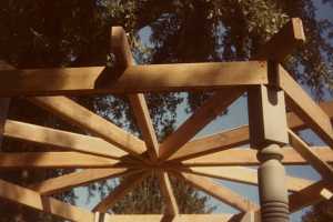 looking up at the top of a wooden gazebo