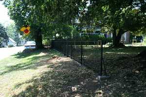 a newly installed black iron fence