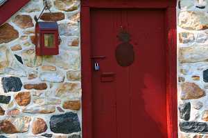 A restored 1794 spring house with red door