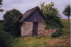 An old spring house surrounded by trees