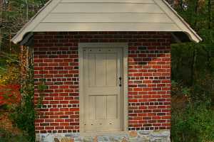 A fully restored red brick spring house