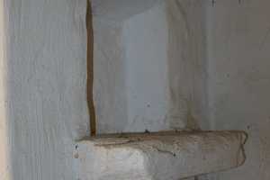 Closeup of a white wall inside a spring house