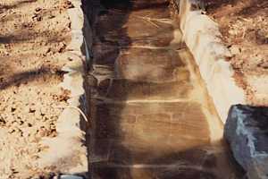 Water flowing out of a spring house built in 1989