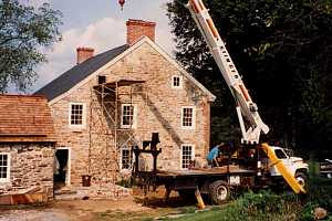 scaffolding and a crane beside a historic stone building