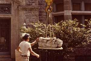 A decorative stone piece of an archway being transported for repair