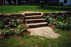 a stone wall and steps with a stone landing - completed