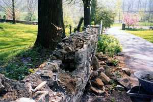 a stone wall that is falling apart