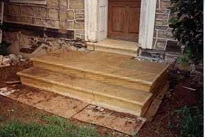 custom stone steps leading to a front door