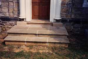 custom stone steps leading to a front door