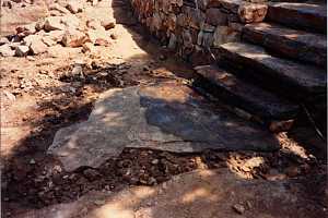 a natural flagstone landing beneath stone steps