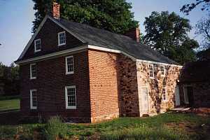 a fully restored stone wall on a brick and natural stone home